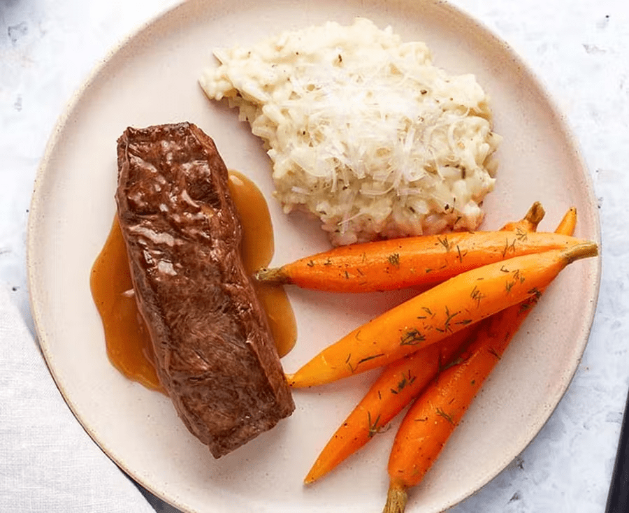 Peppercorn flat iron steak with baby carrots, dill, creamy parmesan risotto