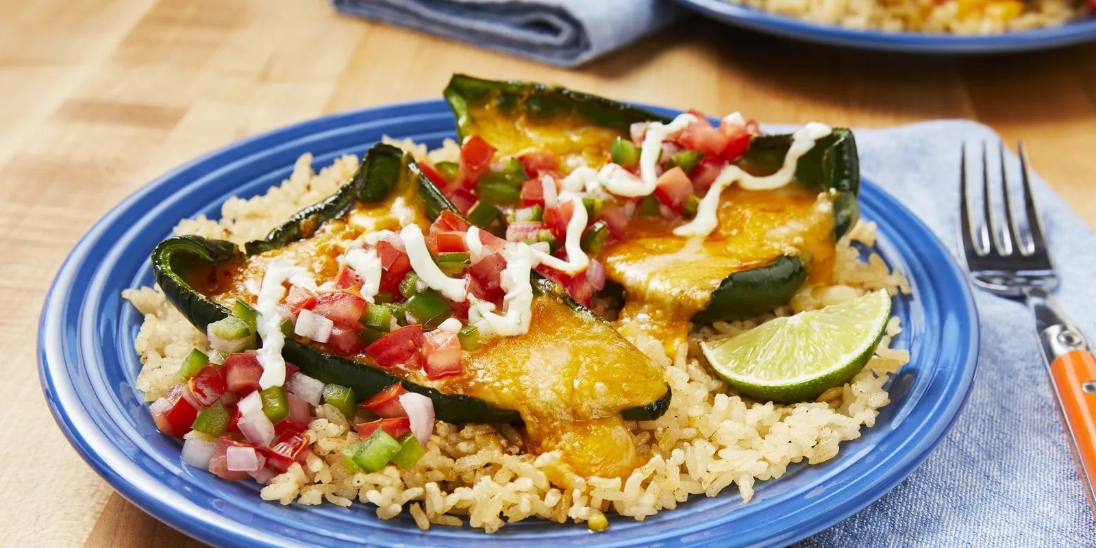 Cheesy Stuffed Green Peppers with Pico de Gallo, Spiced Rice, and Zesty Crema