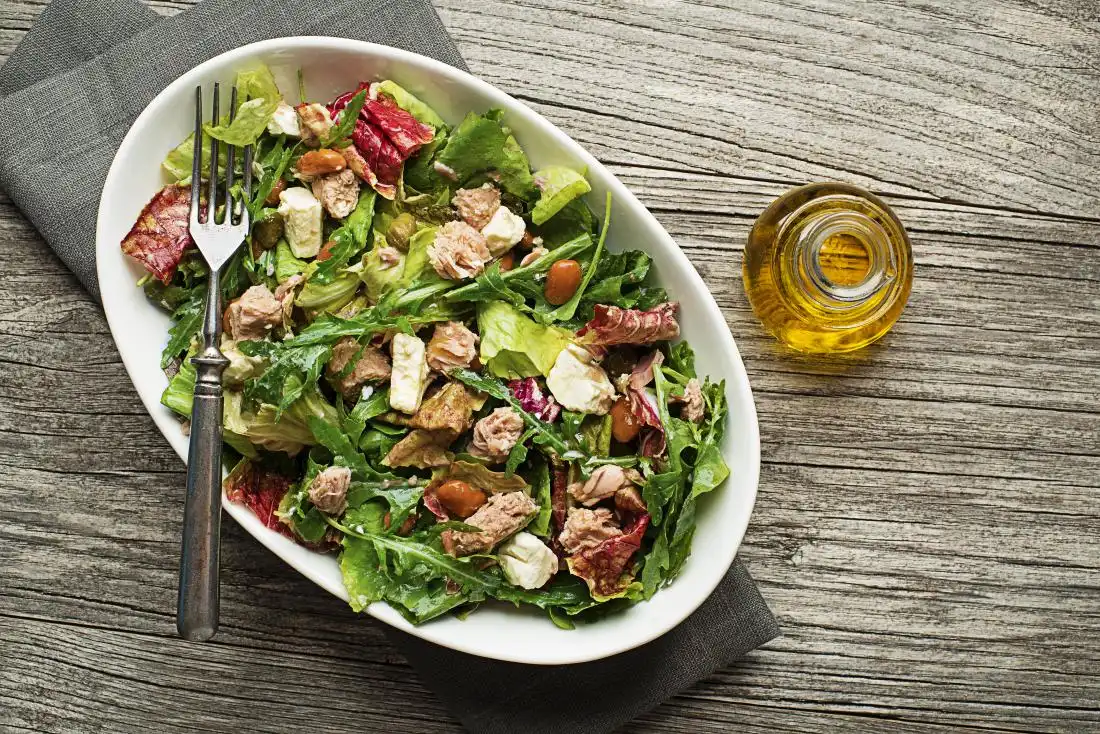 chicken-salad-in-bowl-top-down-view-with-olive-oil-in-jar