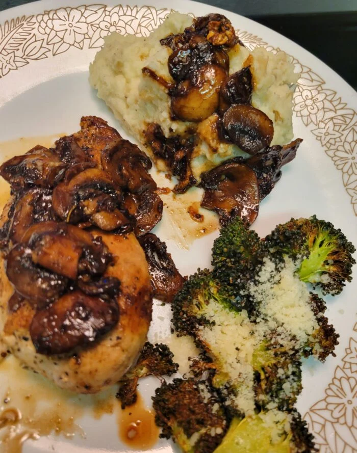 Blue Apron chicken topped with mushroom agrodolce, mashed potatoes and roasted broccoli with parmesan on a plate
