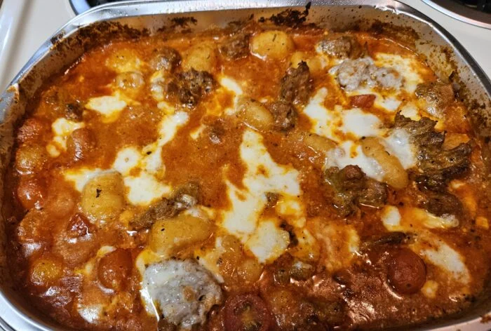 Blue Apron hot Italian sausage and gnocchi baked in tomato sauce with melted mozzarella in a baking dish