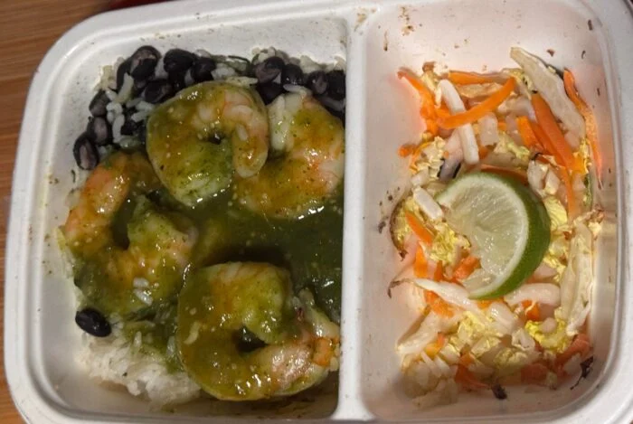 CookUnity adobo verde shrimp bowl with green sauce, rice, black beans and a lime slaw