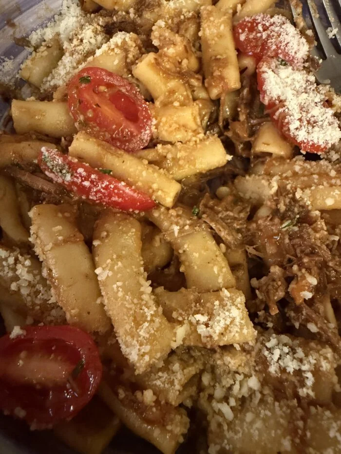 CookUnity pasta Genovese close up, short tube pasta with shredded braised beef, halved cherry tomatoes and grated cheese