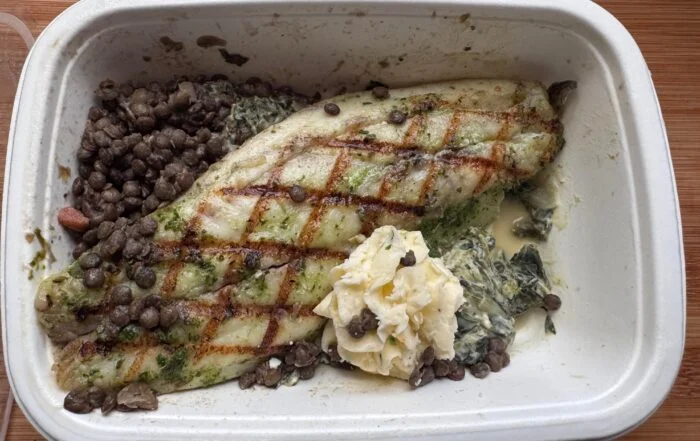 CookUnity grilled branzino fillet with lentils and creamed spinach in the tray