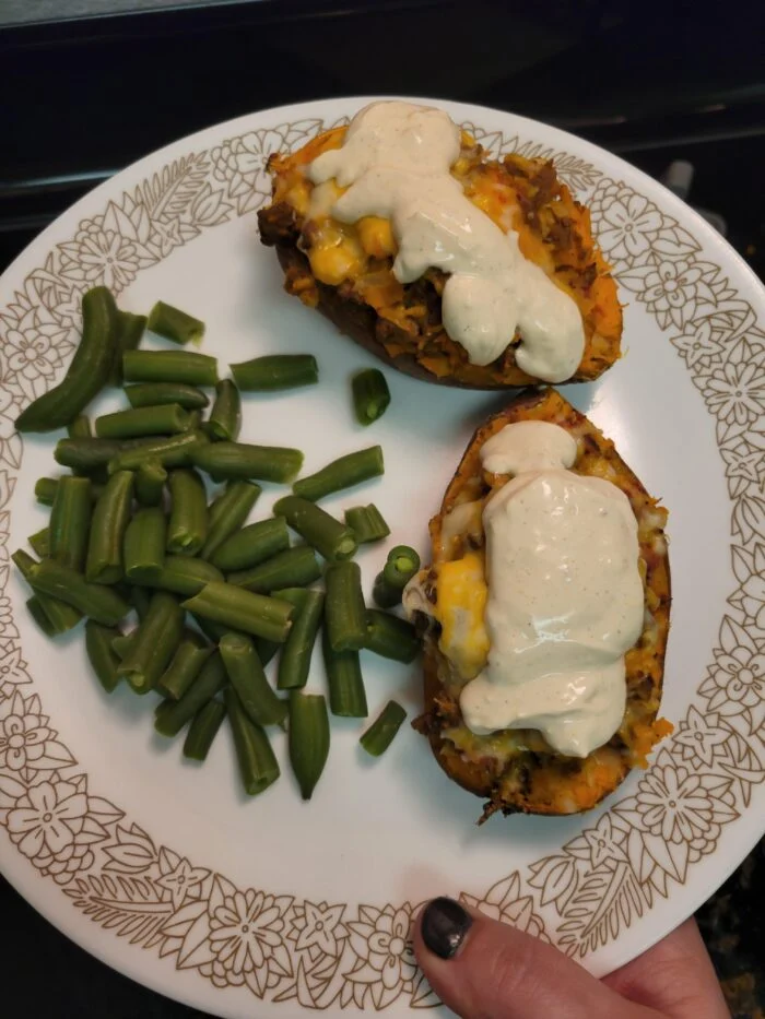 EveryPlate southwest turkey stuffed sweet potato halves with cheese, corn and creamy sauce, green beans on a plate