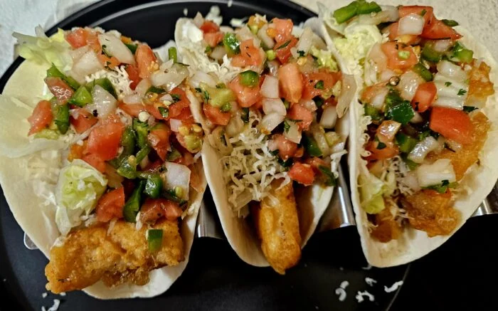 Marley Spoon Baja fish tacos with battered fish, pico de gallo, shredded cabbage and cheese in a taco holder