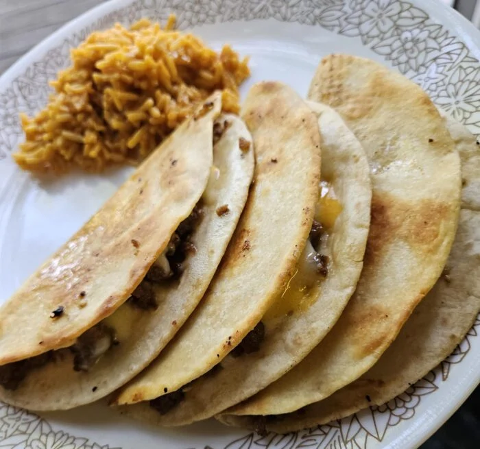 Marley Spoon Korean beef quesadillas, folded and crisped with melted cheese, served with seasoned rice on a plate