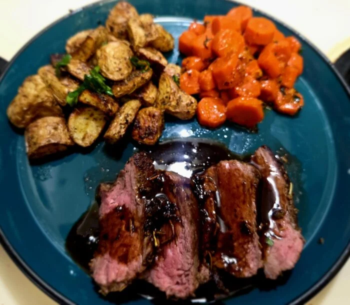 Finished steak with carrots and potatoes, rated 11/10, photographed by u/cera84.