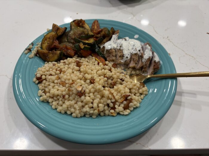 Green Chef pork filet with lemon dill sauce, couscous and roasted squash on a plate