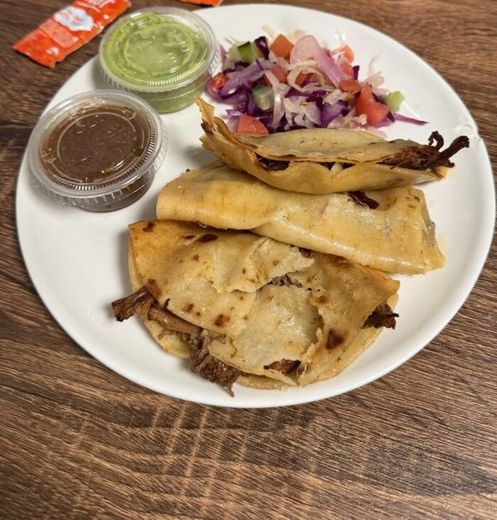 CookUnity beef birria quesadillas with slaw and sauces, plated by a reader.