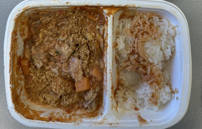 Reader photo of CookUnity Ghanaian chicken peanut stew with sweet potatoes beside rice in its delivery tray