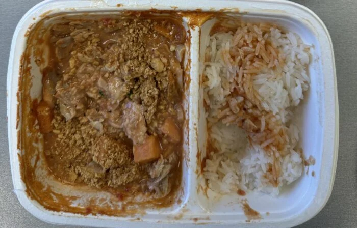Reader photo of CookUnity Ghanaian chicken peanut stew with sweet potatoes beside rice in its delivery tray