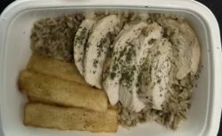 CookUnity sliced roasted chicken over lentil rice with three yuca fries in a white tray
