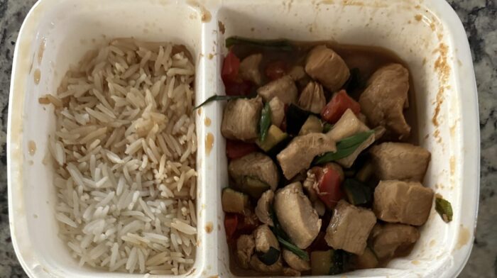 Reader photo of CookUnity Sichuan kung pao chicken with peppers beside basmati rice in its delivery tray