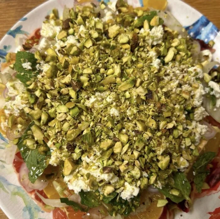 Dinnerly citrus salad with feta, pistachios and mint, shown from above.