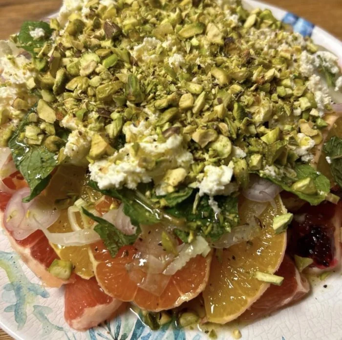 Dinnerly citrus salad with feta, pistachios and mint, shown from the side.