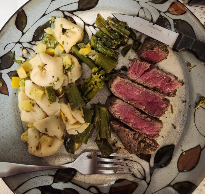 Factor steak with Parmesan tortellini and green beans, plated by a reader.