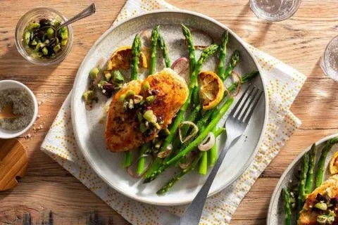 Paprika rubbed chicken breasts with asparagus and olive tapenade