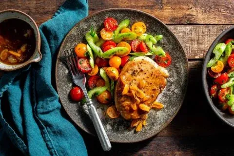 Pork chops with apricot mostarda and tomato celery salad
