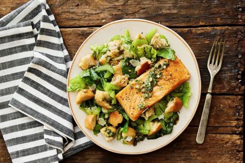Salmon panzanella salad with crisp lettuce, salsa verde, and Parmesan