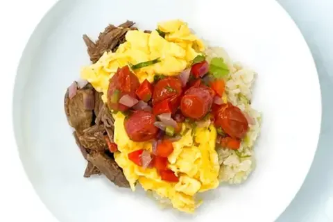 Beef Barbacoa and Scrambled Eggs With Grits And Roasted Pico De Gallo