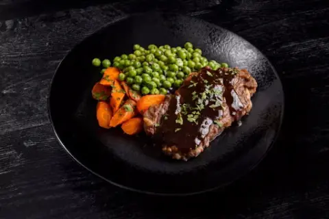 Sliced Bistro Steak with Glazed Peas and Carrots